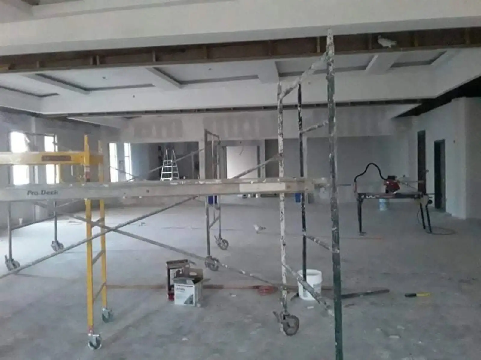Drywall and framing stage of a commercial build-out awaiting rough clean