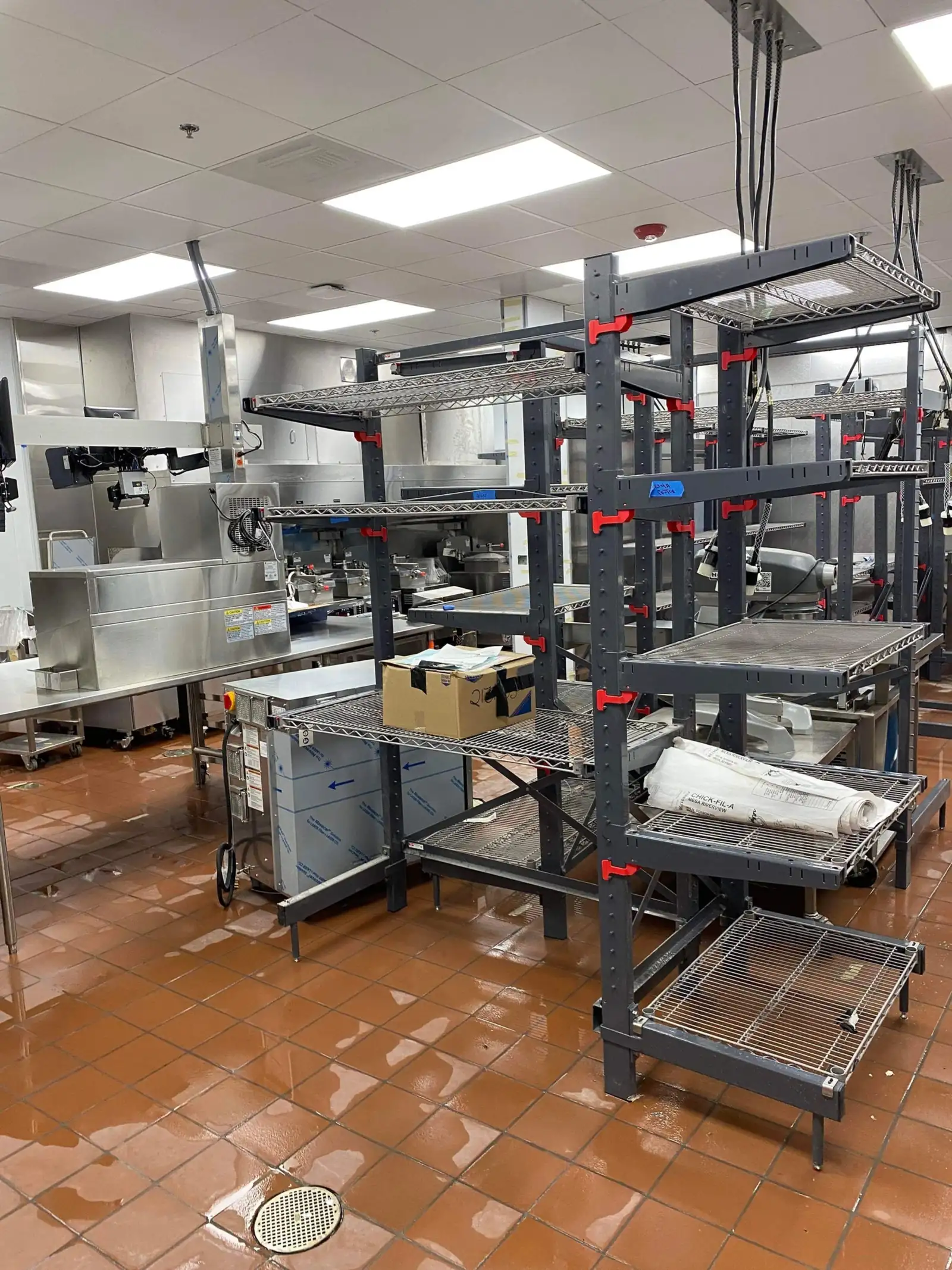 Commercial kitchen storage racks and equipment during a restaurant deep clean