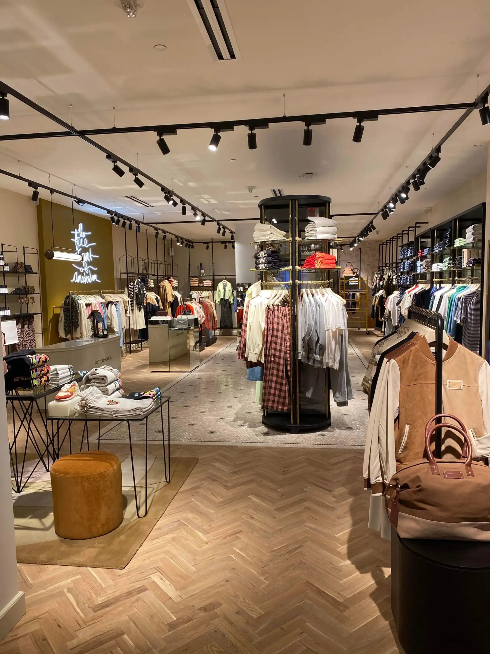 Apparel retail floor with herringbone wood flooring maintained by scheduled janitorial service
