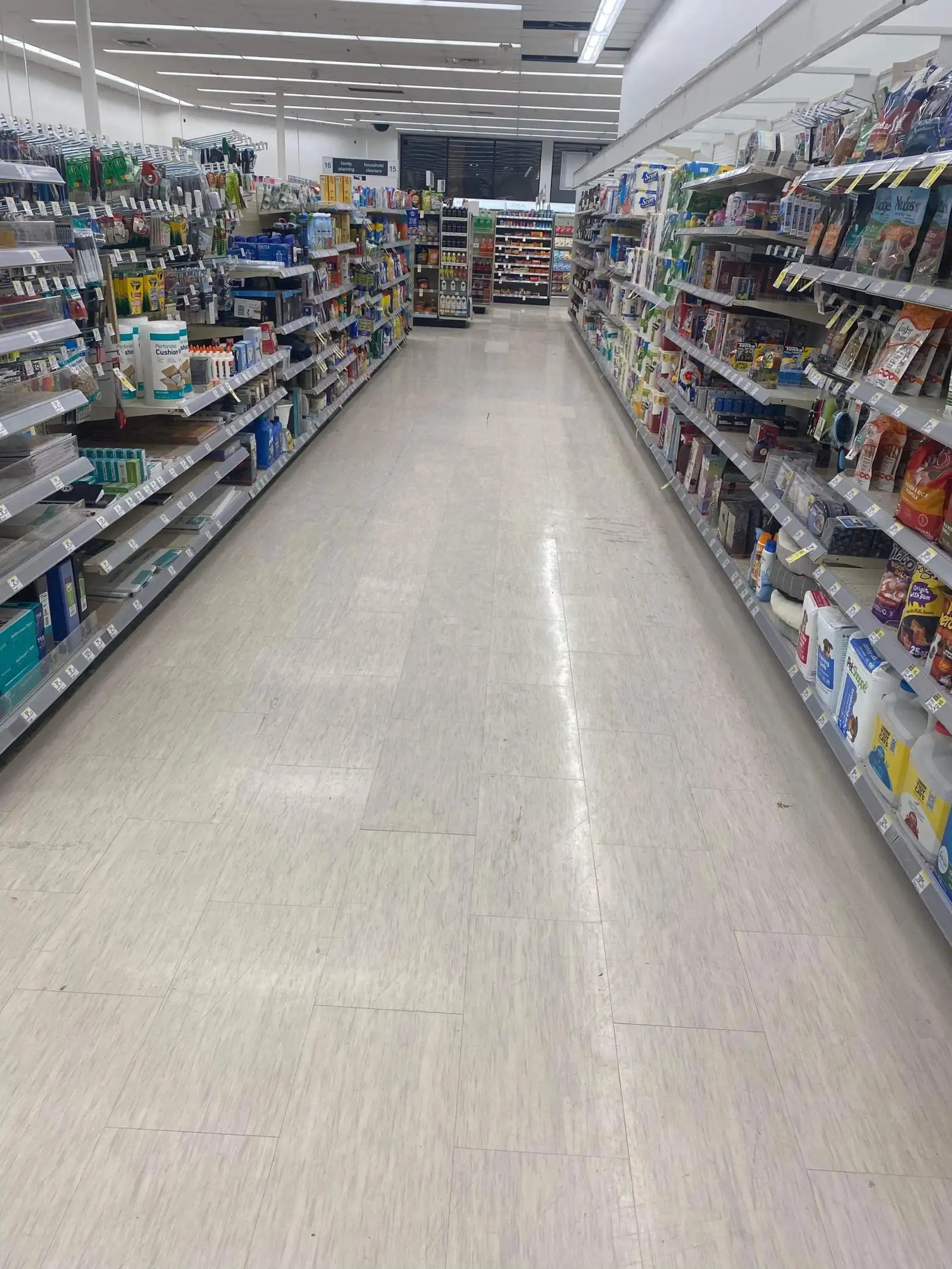 Retail store aisle with polished flooring after scheduled janitorial service