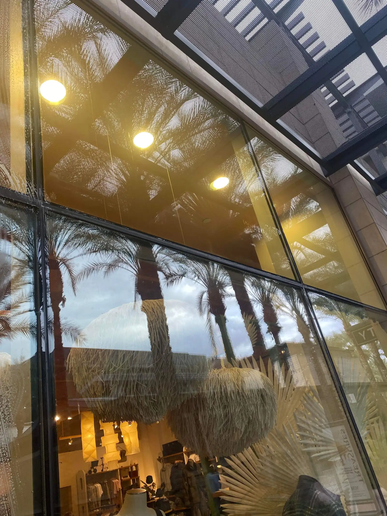 Streak free storefront glass with warm interior lighting visible through the windows